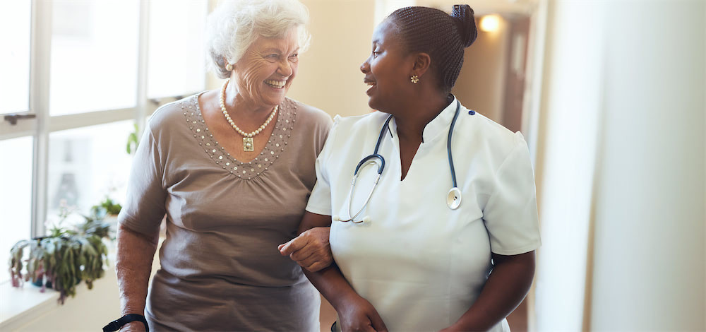 elderly woman talking to hospice nurse